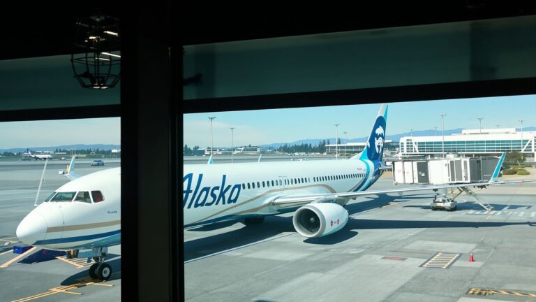 Alaska Airlines jet at West Coast airport gate.