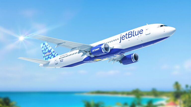 JetBlue airplane flying over tropical landscape.