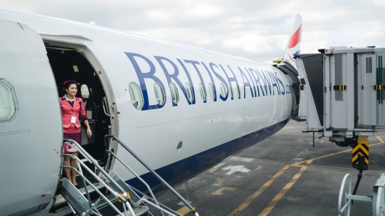 British Airways plane and flight attendant in new uniform.