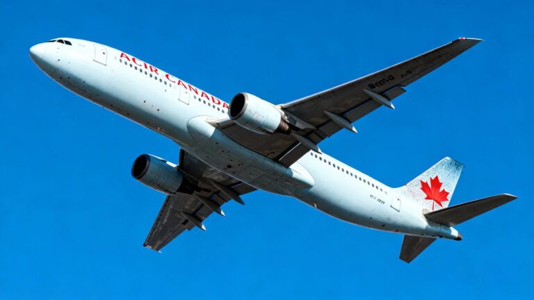 Air Canada airplane flying in a blue sky.