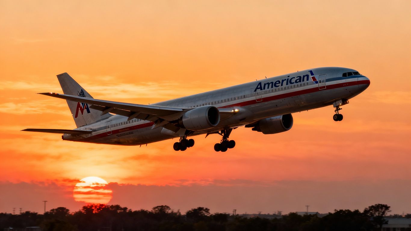 American Airlines jet flying into a sunset.